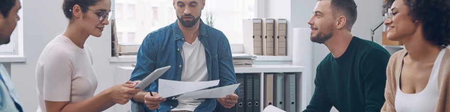 Confident business team having meeting while sitting in the office together