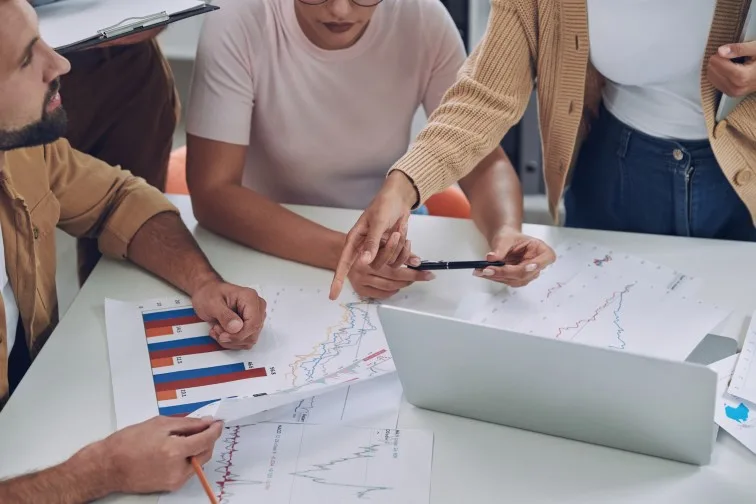 Close-up top view of modern young people in smart casual analyzing data while having meeting in office