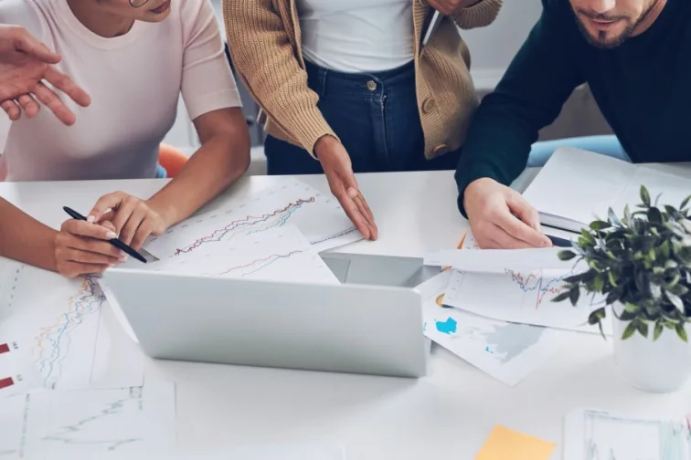 Close-up top view of modern people in smart casual analyzing data while having meeting in office